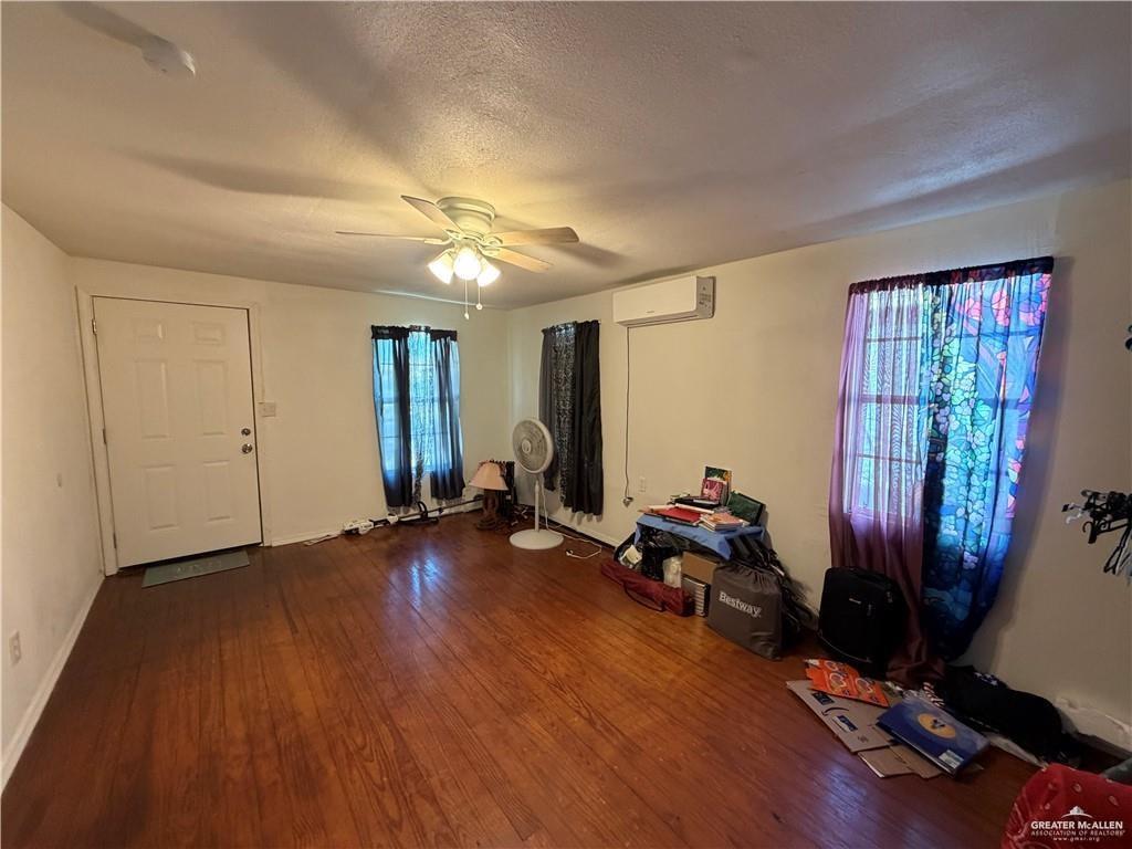 865 Rio Grande Street San Benito, TX 78586 - Photo 4 of 10 a view of a room with wooden floor and windows