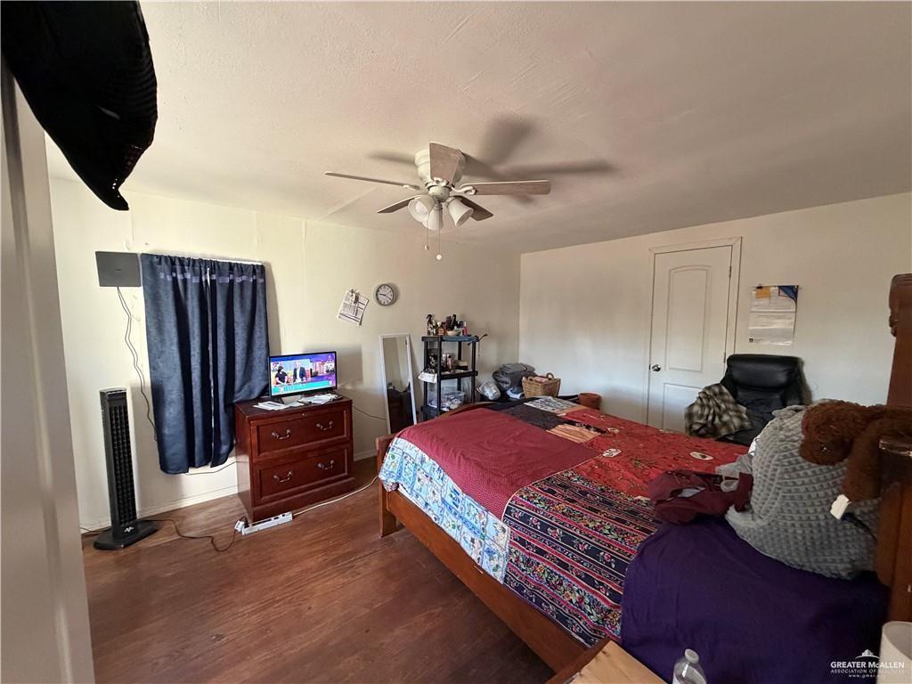 865 Rio Grande Street San Benito, TX 78586 - Photo 10 of 10 a bedroom with a bed and a flat tv screen on the dresser