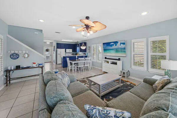 a view of a kitchen with kitchen island a sink appliances and a counter top space
