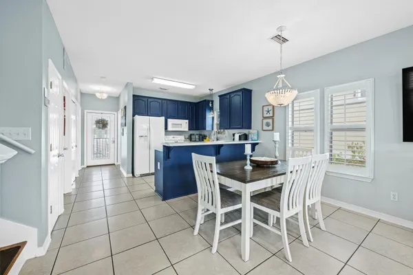a bedroom with two beds and a chandelier