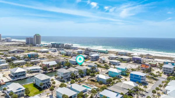 a small pool with lawn chairs under an umbrella