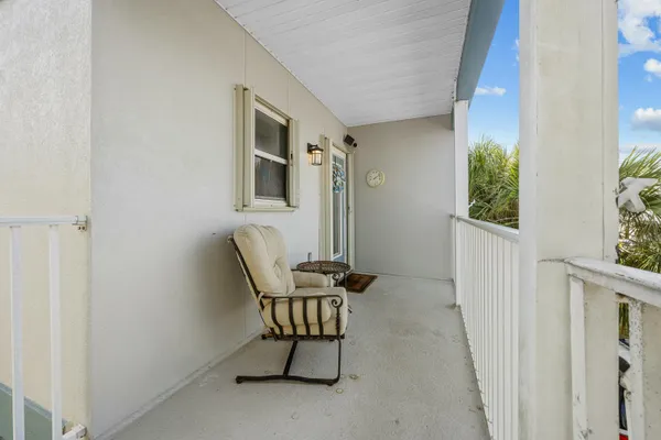 a kitchen with a refrigerator a sink and wooden cabinets