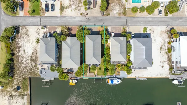 a view of a patio with table and chairs with wooden floor and fence