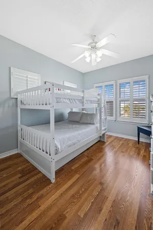 a spacious bathroom with a granite countertop sink a toilet and a mirror