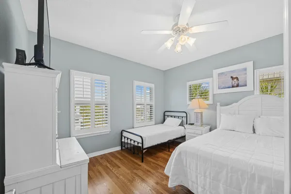 a spacious bedroom with a bed and a chandelier