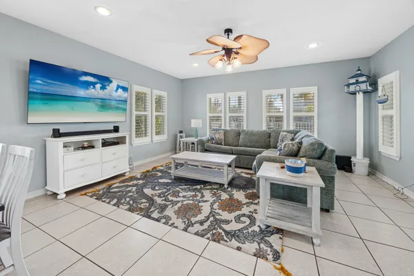 a kitchen with stainless steel appliances a refrigerator a stove a sink dishwasher with a dining table and chairs