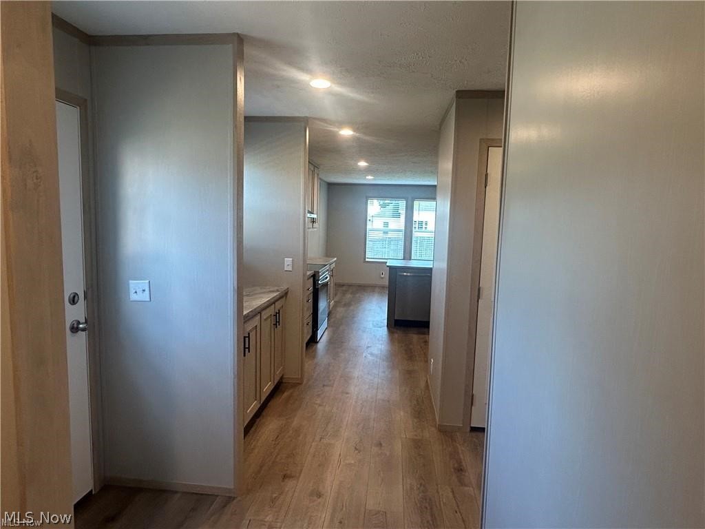252 Front Street Philo, OH 43771 - Photo 3 of 17 Corridor featuring light wood-style floors, recessed lighting, and a textured ceiling