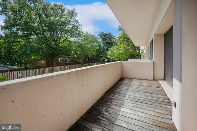 a view of balcony with wooden floor and fence