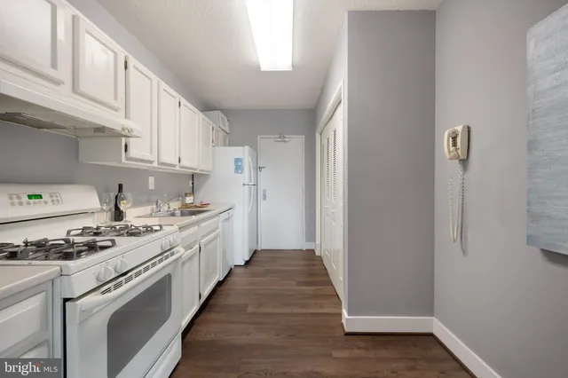 a kitchen with stainless steel appliances a stove a refrigerator and cabinets