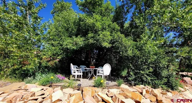 a view of backyard with sitting area