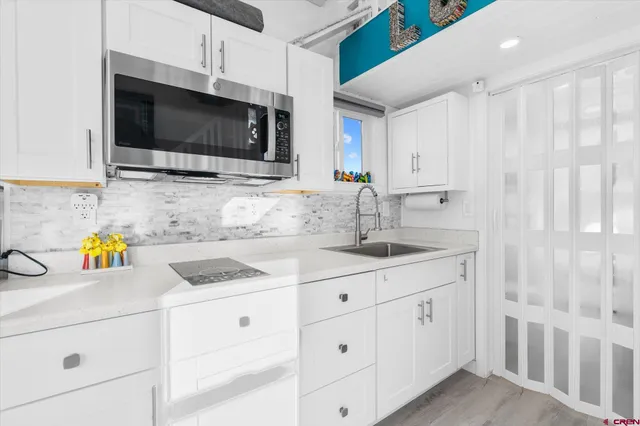 a kitchen with a sink and a stove top oven