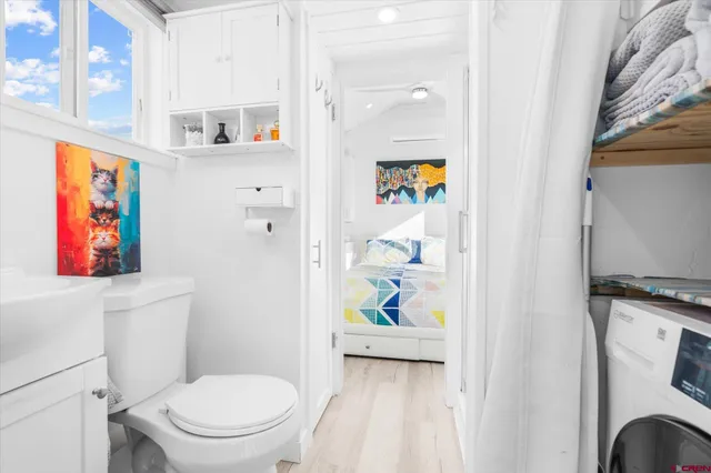 a white toilet sitting next to a bathroom sink
