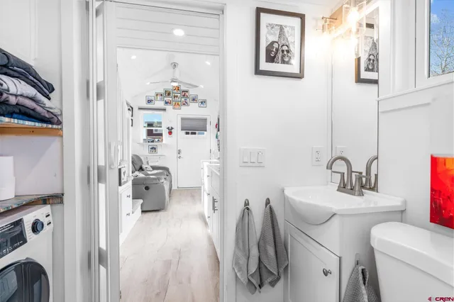 a en suite bathroom with a sink mirror and toilet