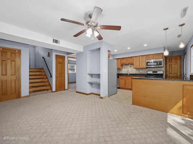 a view of a kitchen with a sink and a refrigerator
