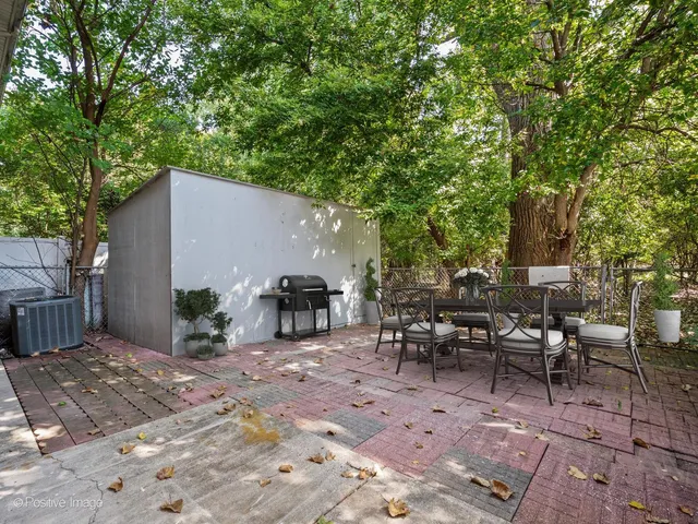 a view of a patio with table and chairs and potted plants