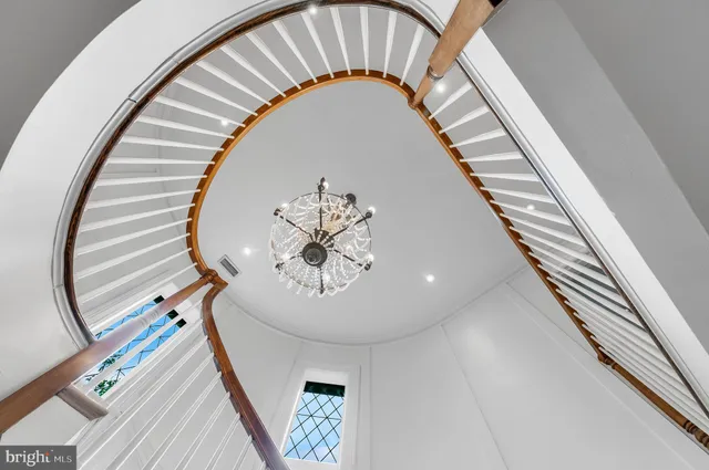 a living room with furniture a large window and wooden floor