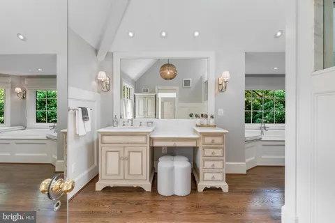 a kitchen with stainless steel appliances refrigerator wooden floor and a window