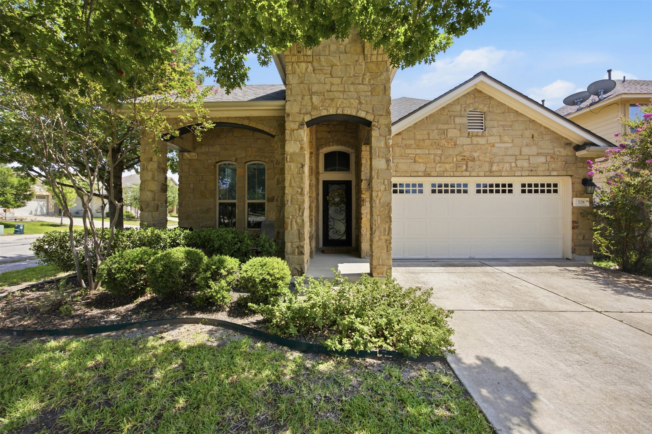 This two story home combines classic architectural details with a warm, welcoming exterior. The covered front porch invites you in from the moment you arrive. Manicured landscaping adds to the polished curb appeal.
