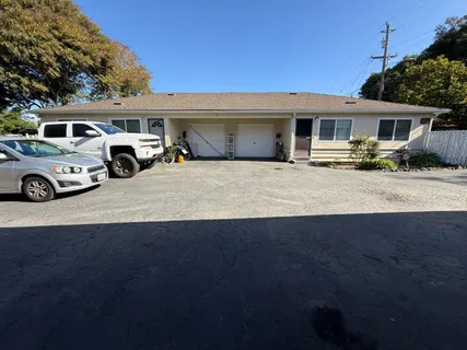 a front view of a house with parking space