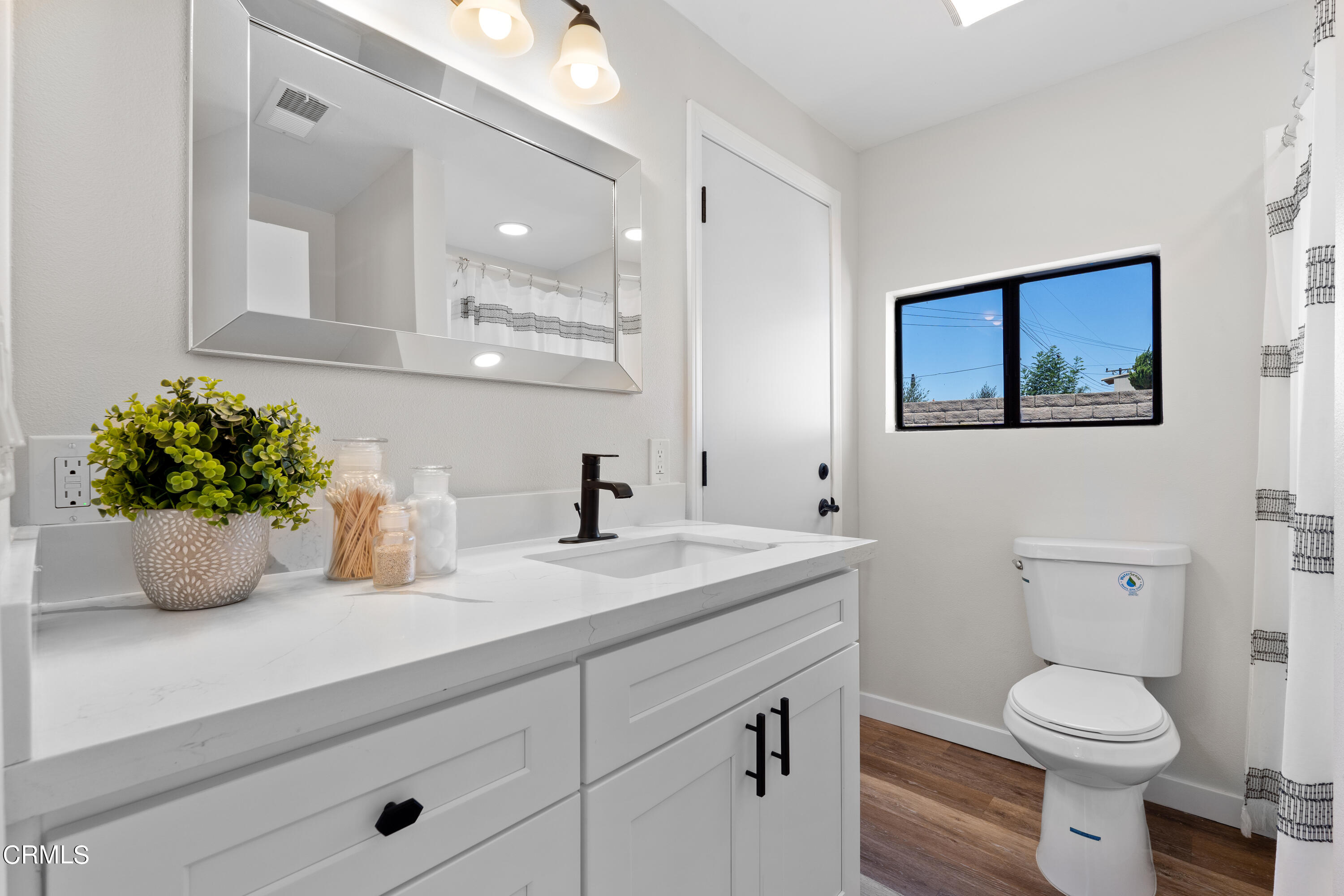 1007 Appleton Road Simi Valley, CA 93065 - Photo 20 of 29 a bathroom with a toilet a sink and mirror