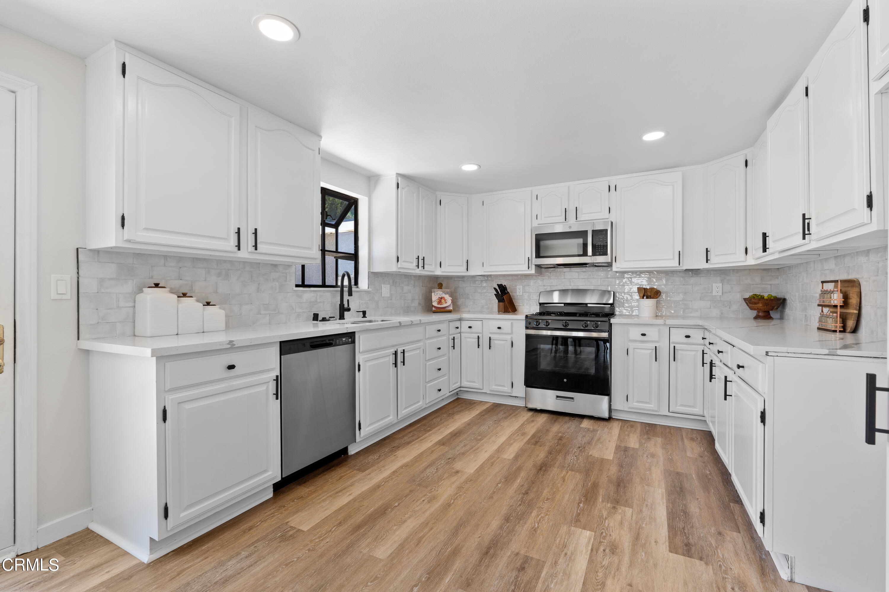 1007 Appleton Road Simi Valley, CA 93065 - Photo 8 of 29 a kitchen with granite countertop white cabinets and white appliances