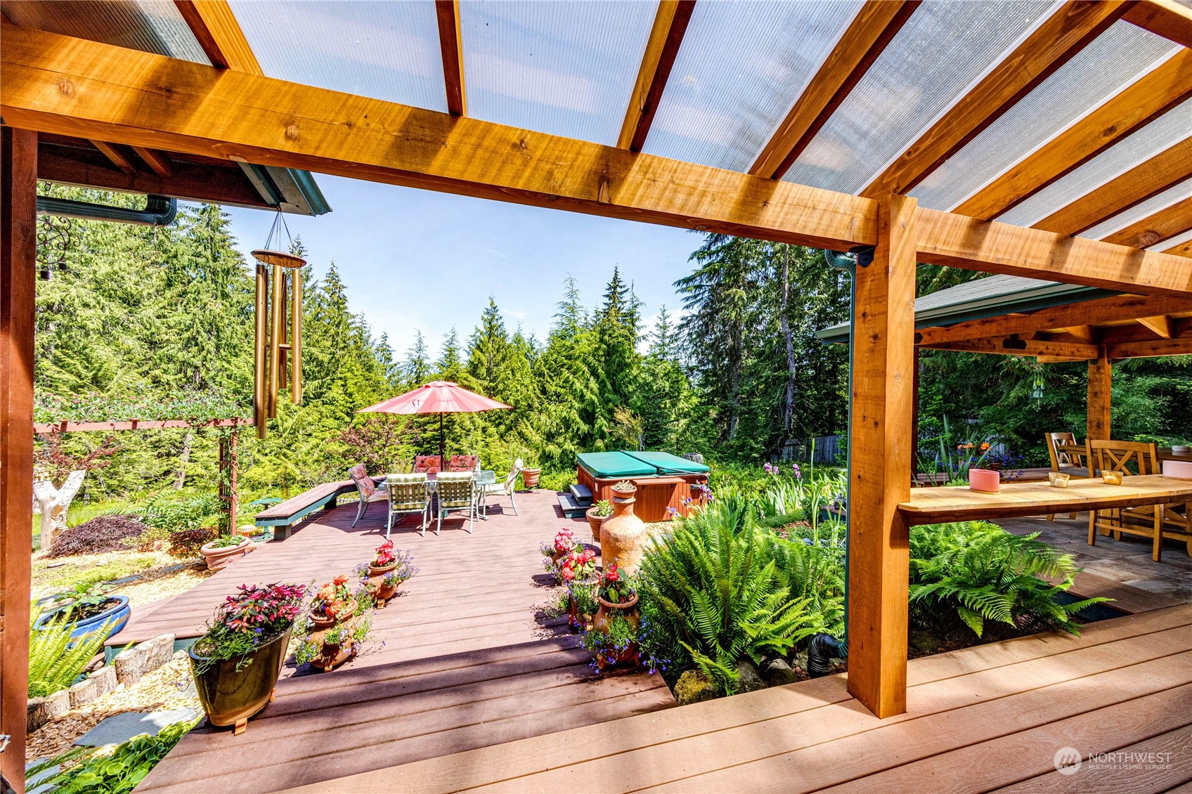 443 Westridge Road Port Angeles, WA 98363 - Photo 16 of 40 a view of a patio with table and chairs potted plants