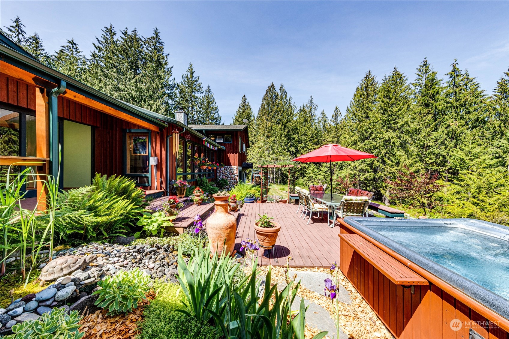 443 Westridge Road Port Angeles, WA 98363 - Photo 18 of 40 a view of a chairs and table under an umbrella in patio