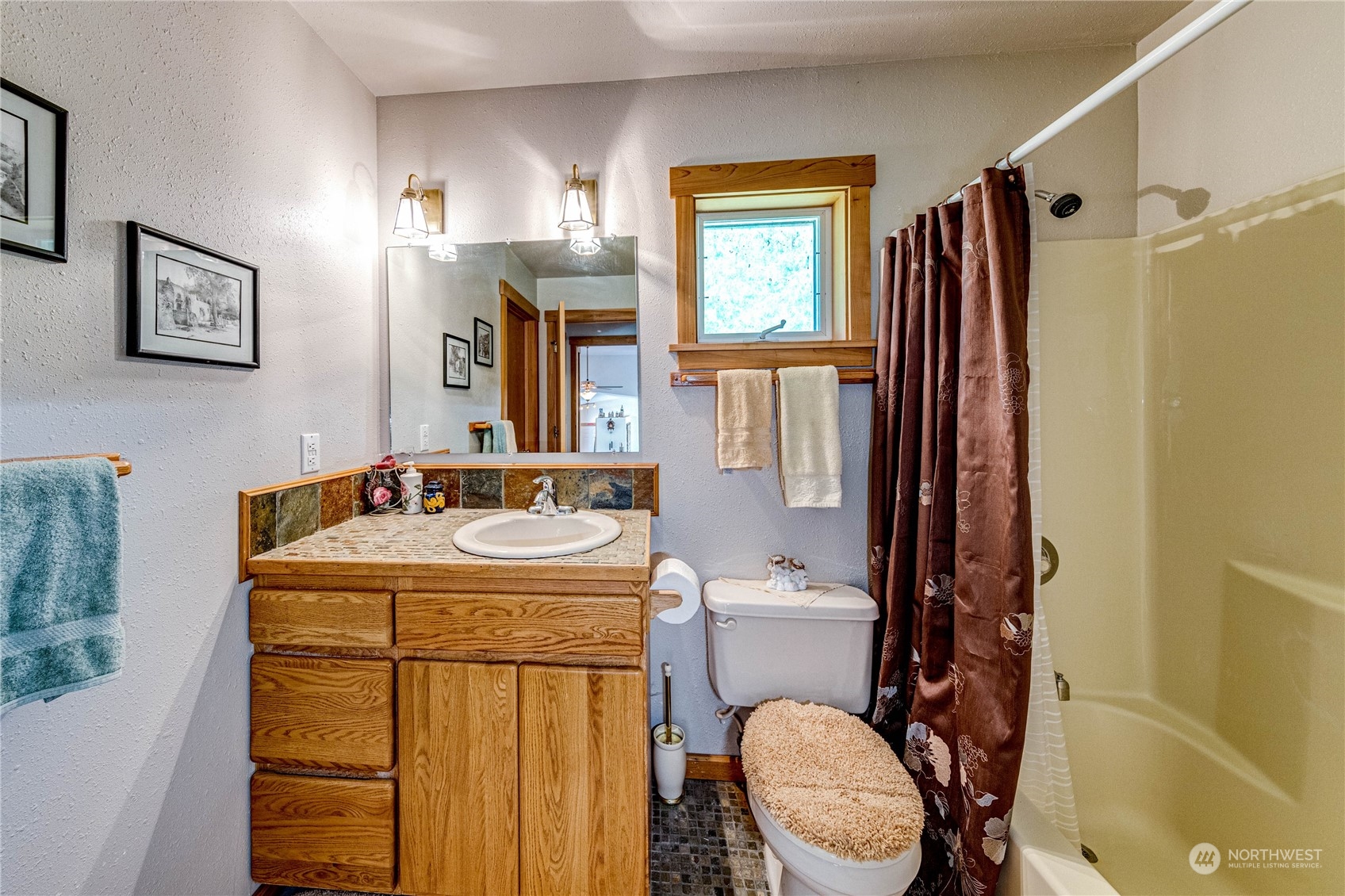 443 Westridge Road Port Angeles, WA 98363 - Photo 23 of 40 a bathroom with a sink a toilet and a mirror