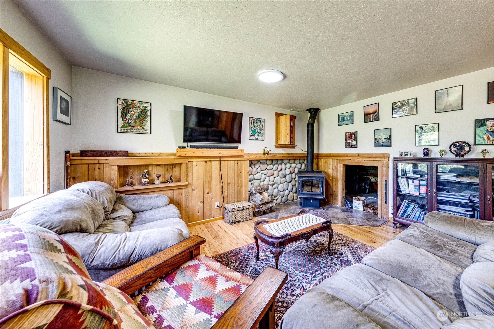 443 Westridge Road Port Angeles, WA 98363 - Photo 27 of 40 a living room with furniture a flat screen tv and a fireplace