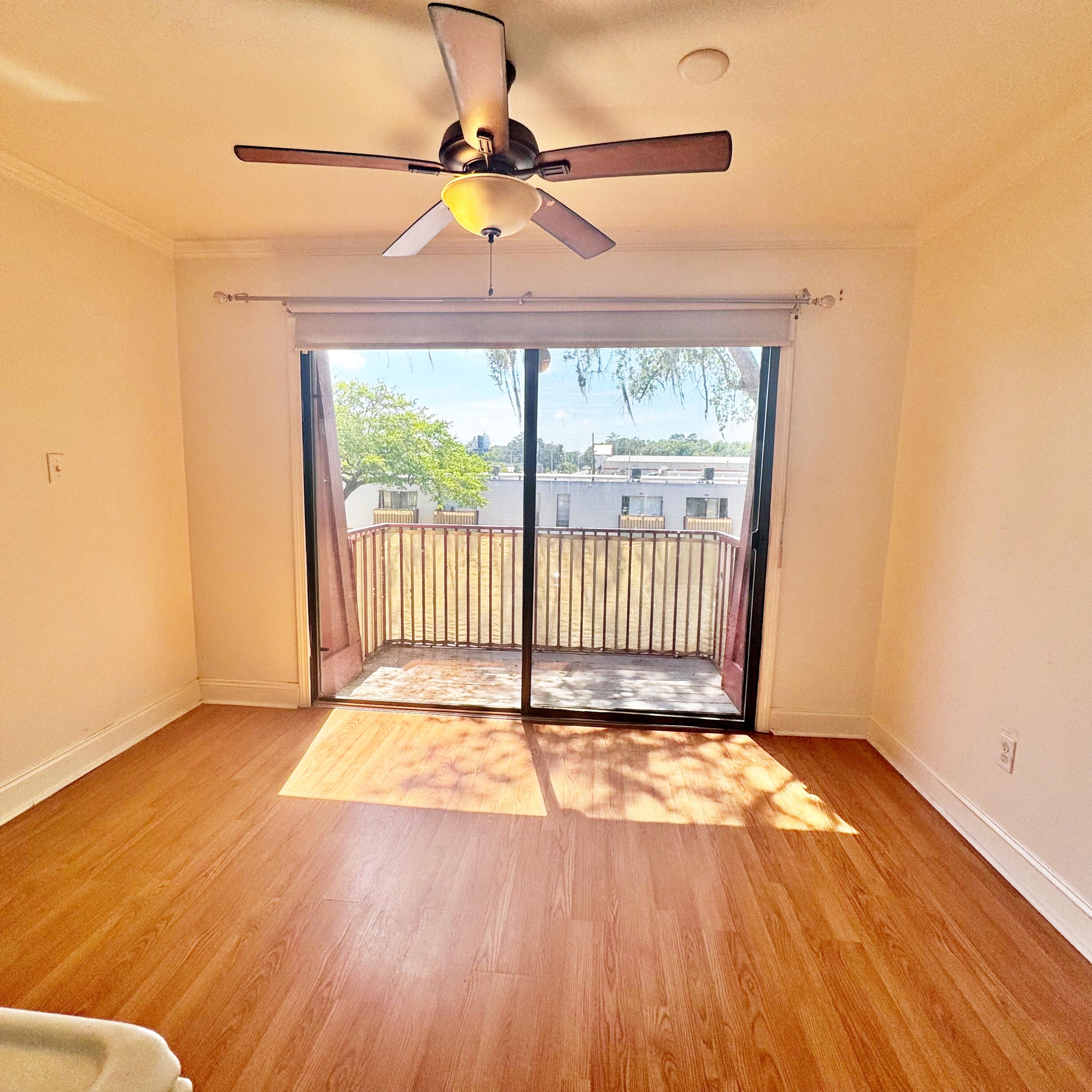 210 Pelham Road, Unit 215B Fort Walton Beach, FL 32547 - Photo 7 of 23 a view of a room with wooden floor and a window
