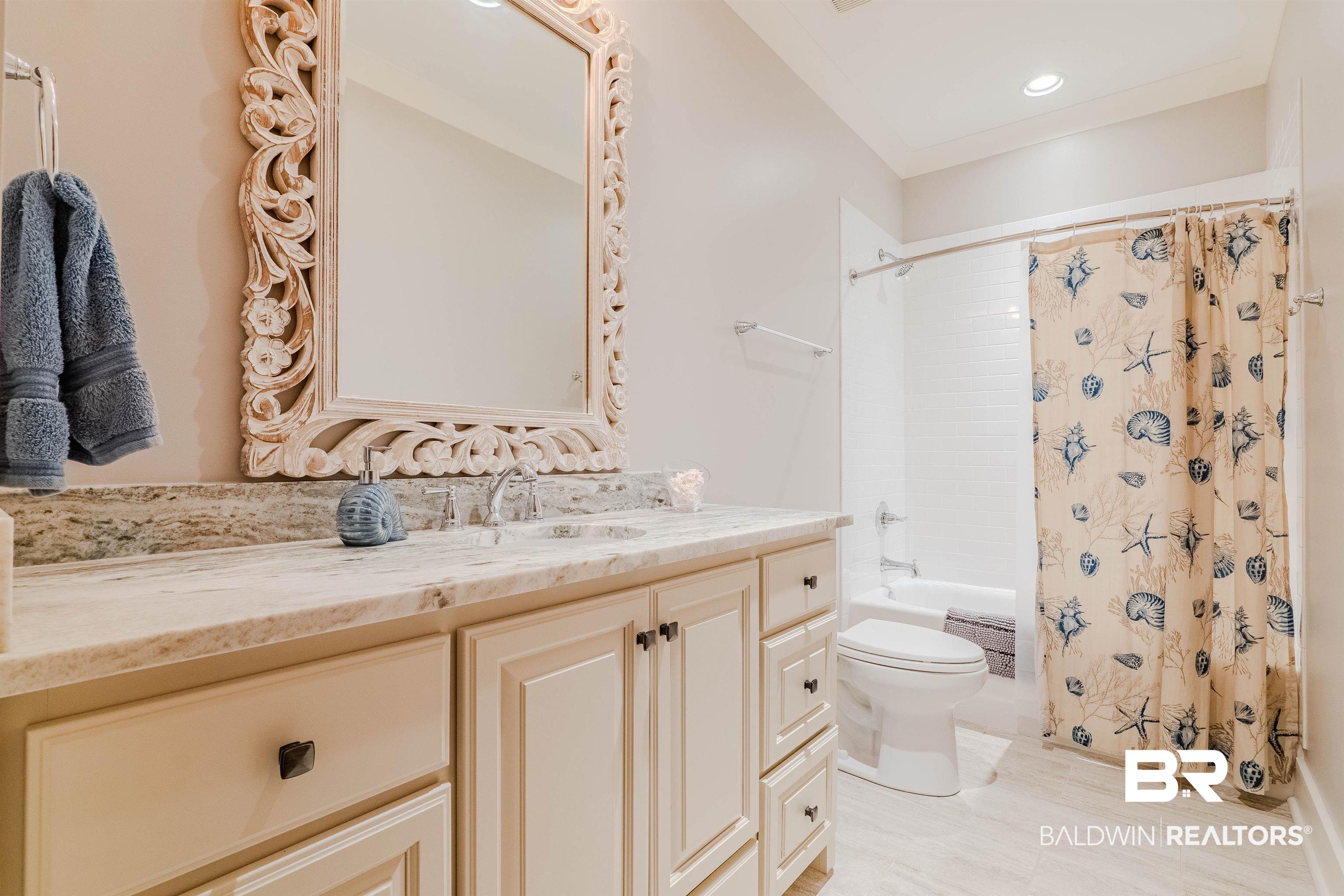 708 Manning Place Fairhope, AL 36532 - Photo 38 of 58 Full bathroom with vanity, toilet, and shower / bath combo with shower curtain