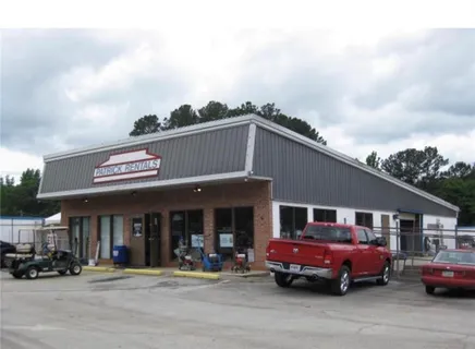 a front view of a building with parking