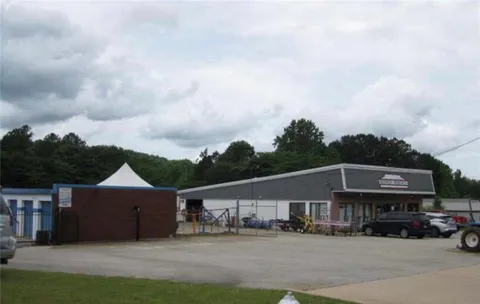 a view of house with yard and entertaining space