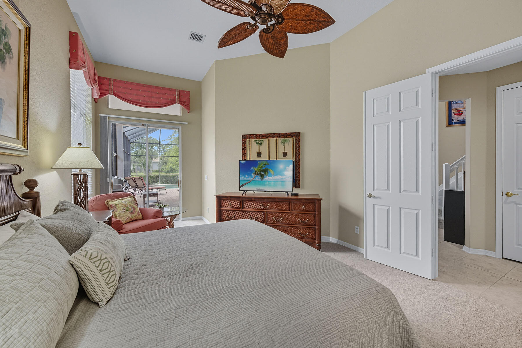 8582 Peppertree Way Naples, FL 34114 - Photo 16 of 50 a bedroom with a bed and a chandelier