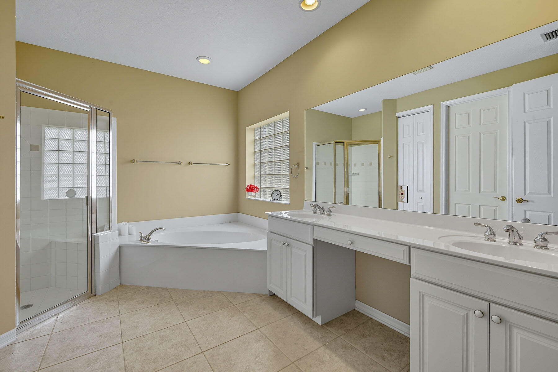 8582 Peppertree Way Naples, FL 34114 - Photo 17 of 50 a bathroom with a tub sink and mirror