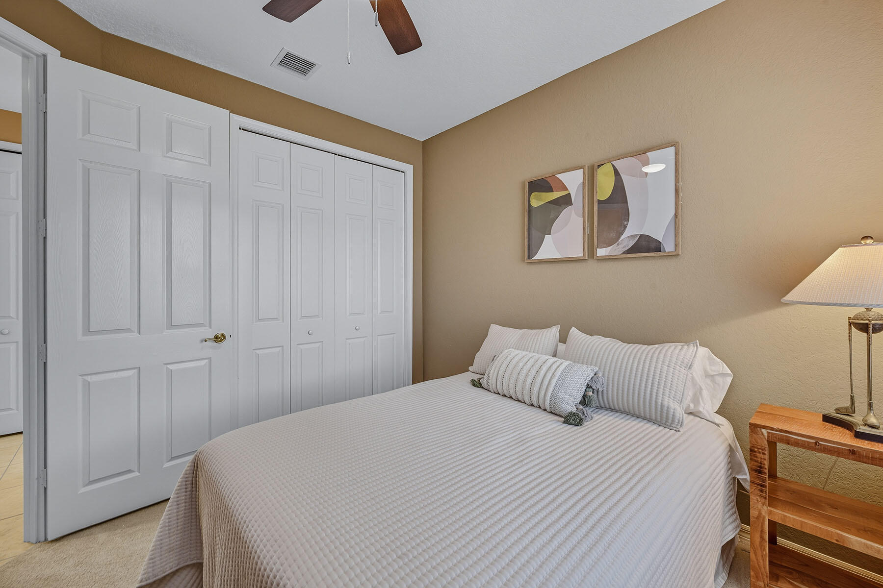 8582 Peppertree Way Naples, FL 34114 - Photo 20 of 50 a bedroom with a bed and a lamp on dresser