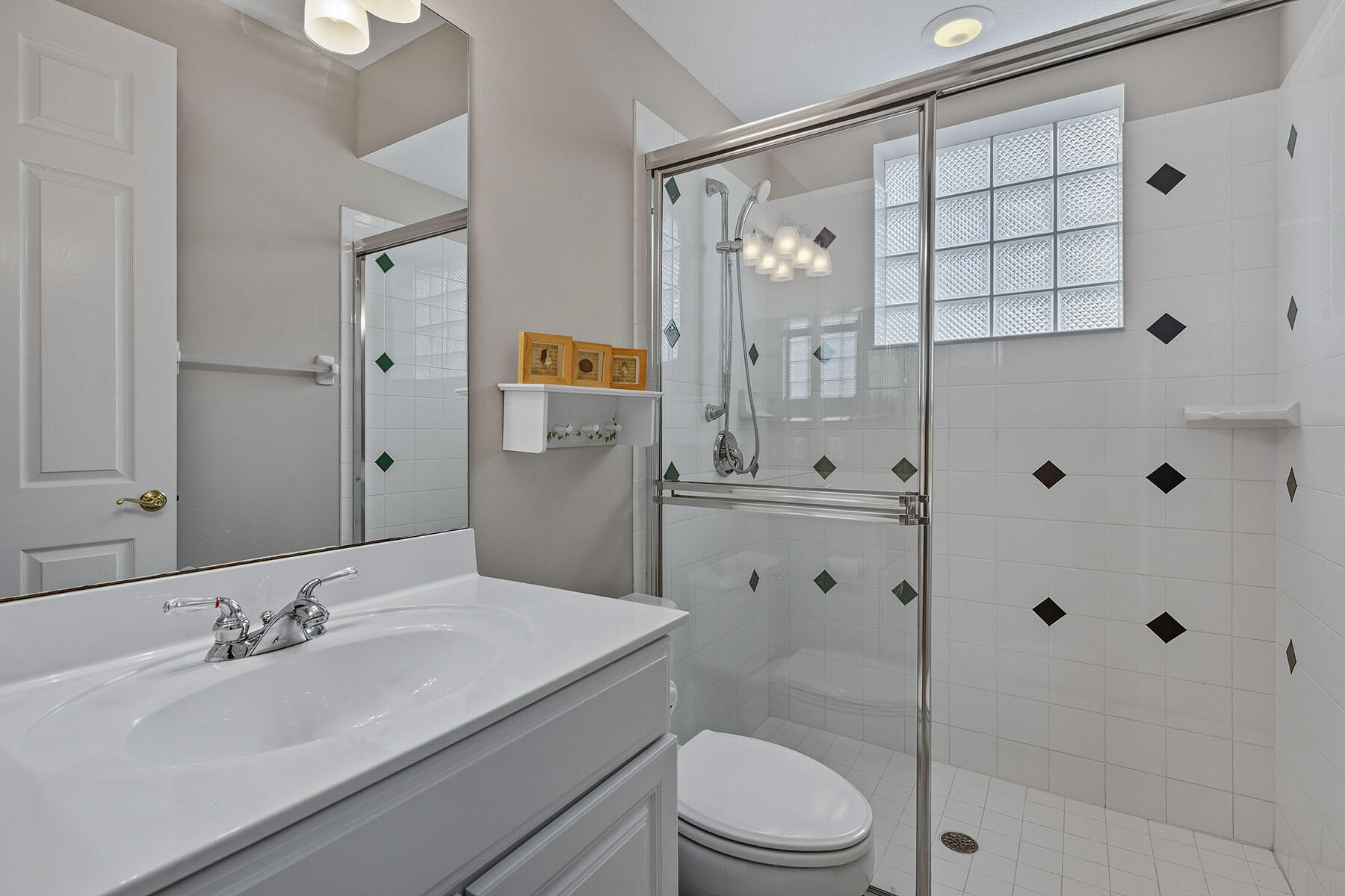 8582 Peppertree Way Naples, FL 34114 - Photo 21 of 50 a bathroom with a granite countertop sink toilet a shower a mirror and a bathtub