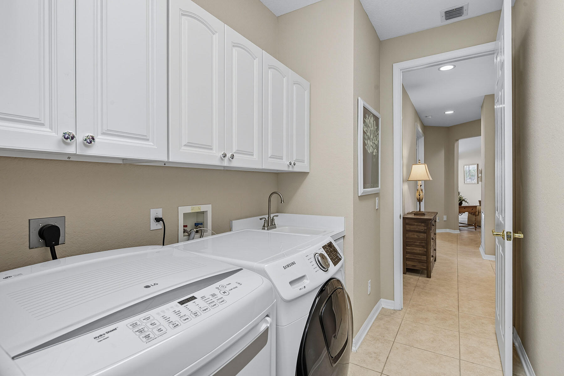 8582 Peppertree Way Naples, FL 34114 - Photo 29 of 50 a utility room with dryer and washer