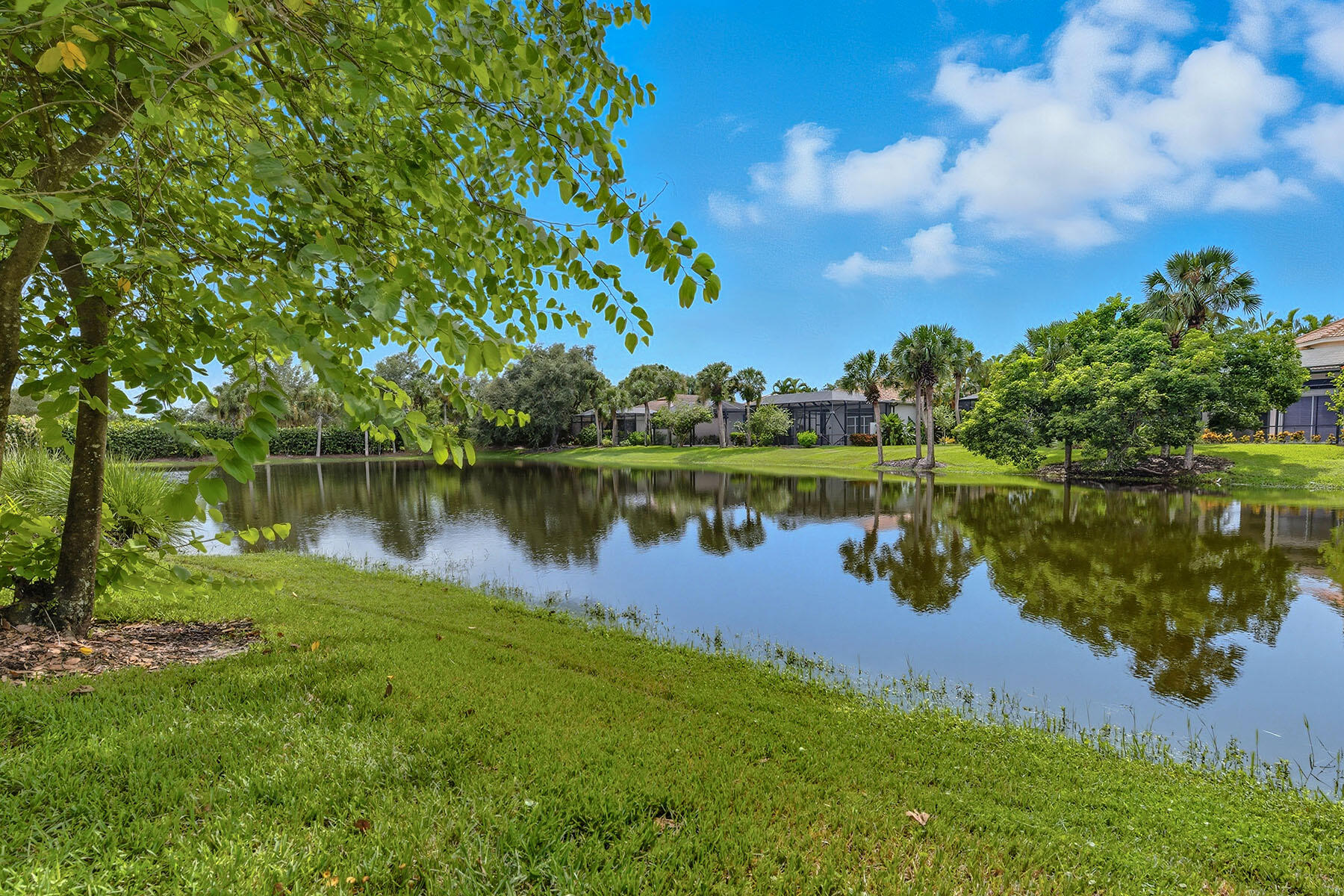 8582 Peppertree Way Naples, FL 34114 - Photo 34 of 50 a view of a lake with a house in the background