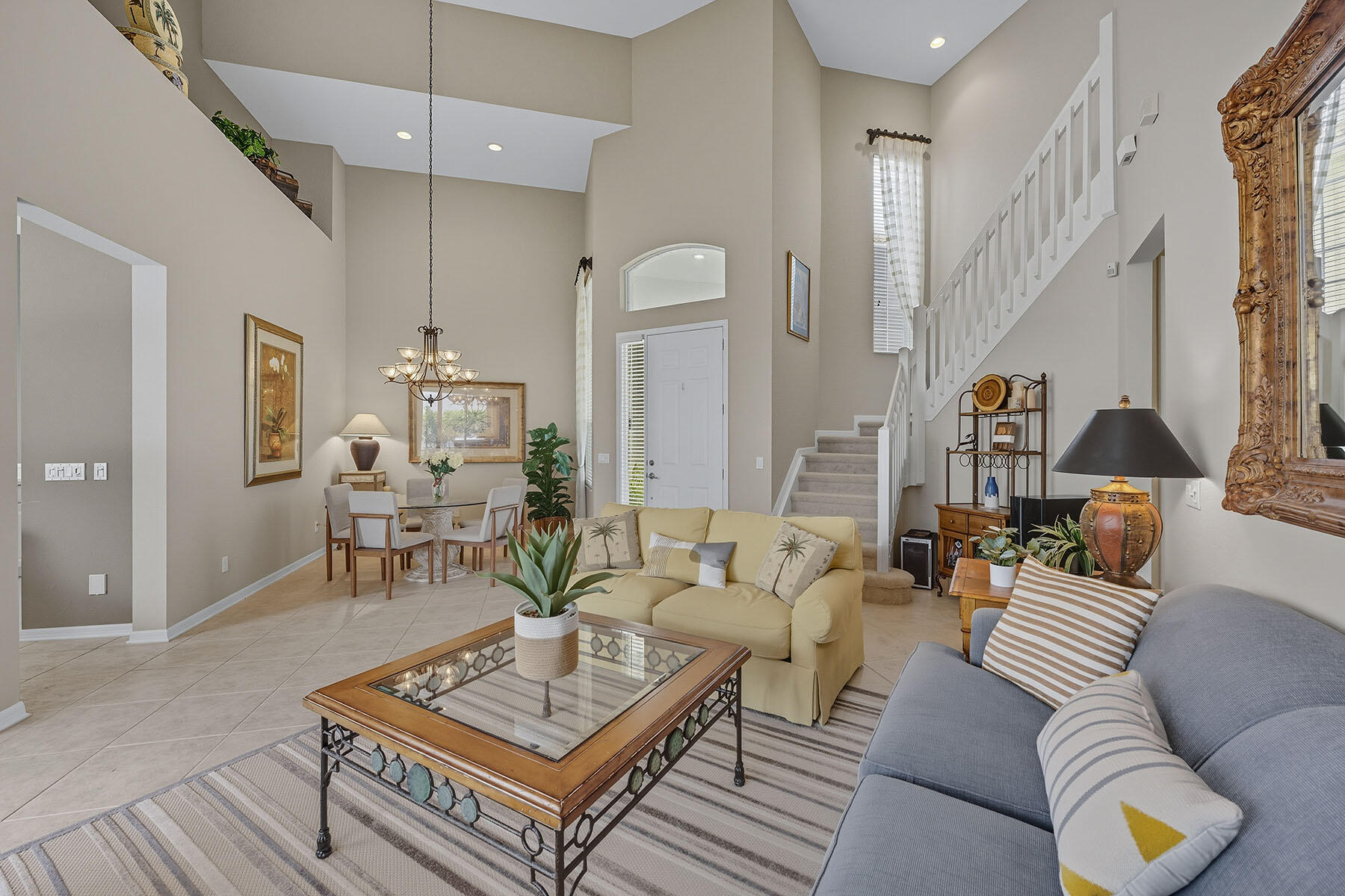 8582 Peppertree Way Naples, FL 34114 - Photo 5 of 50 a living room with furniture a rug and a chandelier