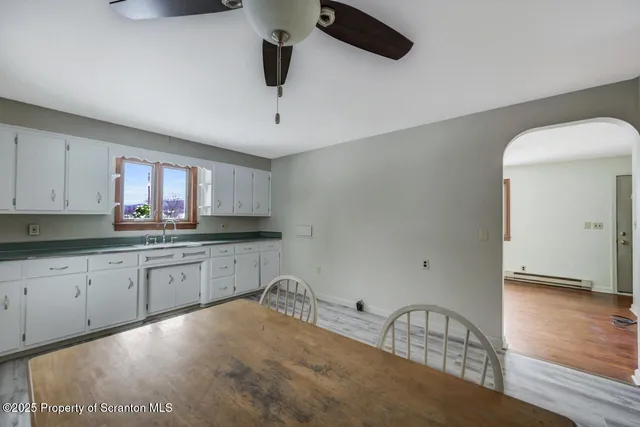 a kitchen with a sink cabinets and window