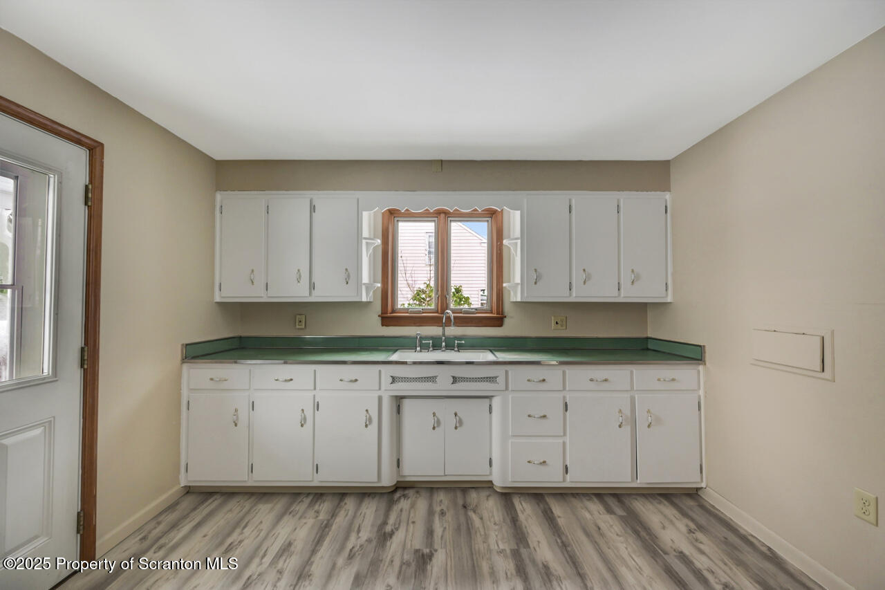 113 Taroli Street Old Forge, PA 18518 - Photo 12 of 41 a view of a kitchen with wooden floor and cabinets