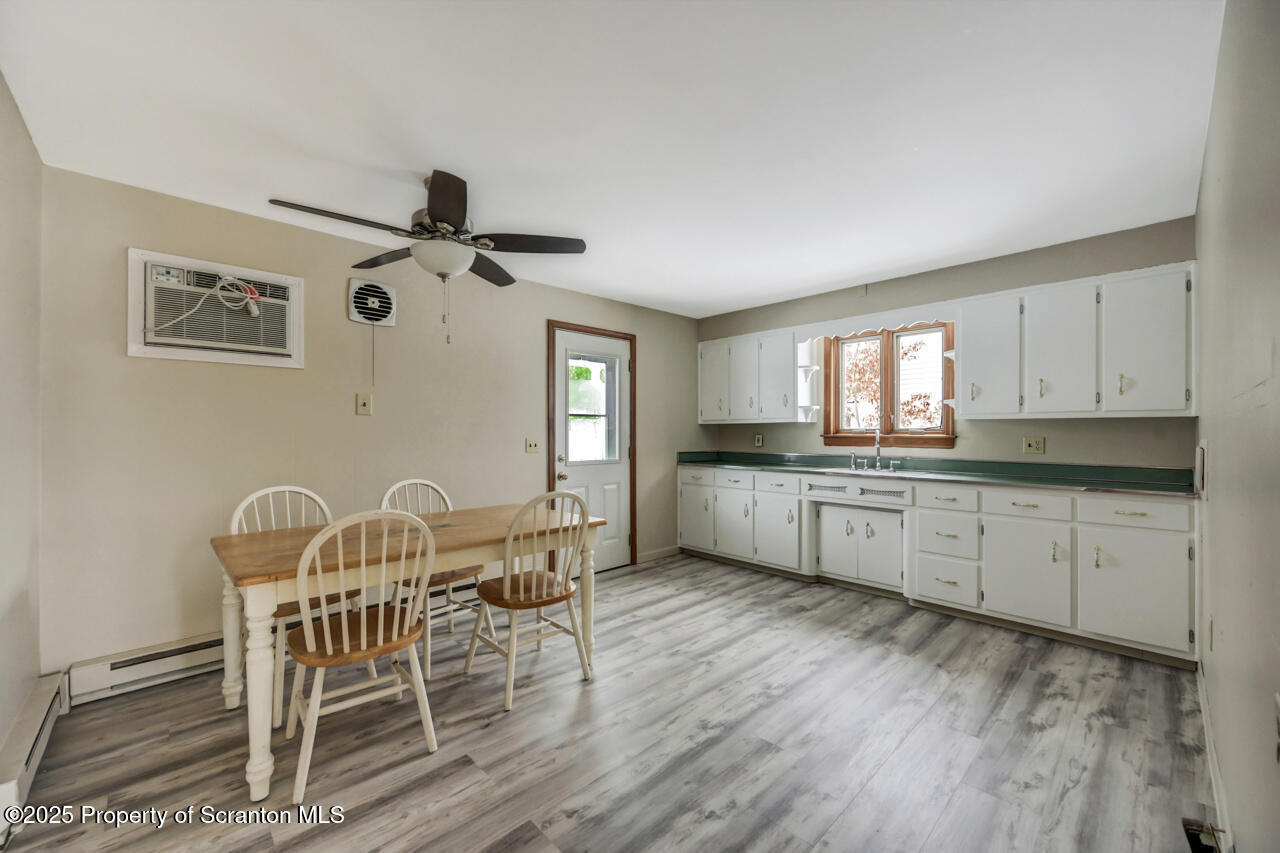 113 Taroli Street Old Forge, PA 18518 - Photo 15 of 41 a kitchen with granite countertop cabinets a dining table and chairs
