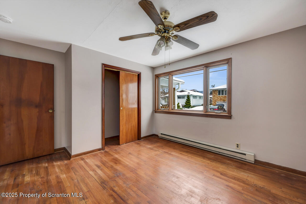 113 Taroli Street Old Forge, PA 18518 - Photo 17 of 41 wooden floor in an empty room with a window