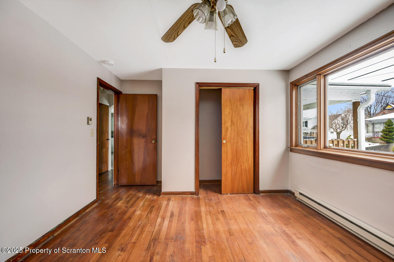 113 Taroli Street Old Forge, PA 18518 - Photo 18 of 41 a view of an empty room with wooden floor and a window