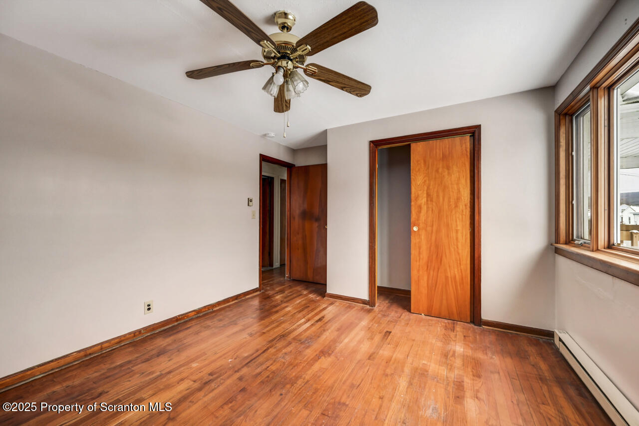 113 Taroli Street Old Forge, PA 18518 - Photo 19 of 41 wooden floor in an empty room with a window