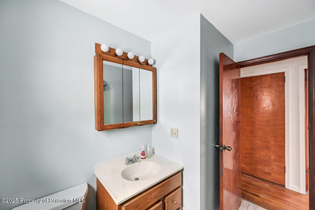 113 Taroli Street Old Forge, PA 18518 - Photo 21 of 41 a bathroom with a sink mirror and vanity