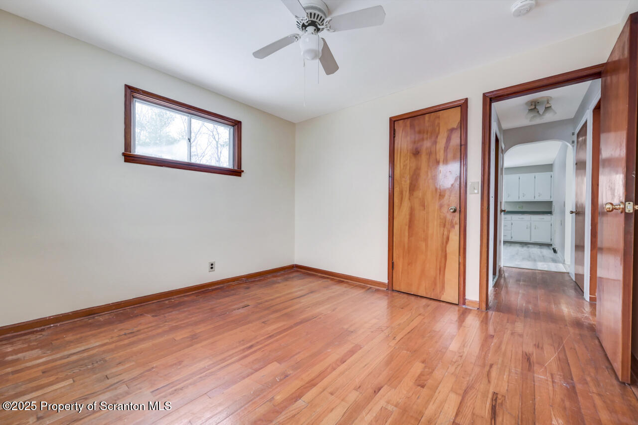 113 Taroli Street Old Forge, PA 18518 - Photo 24 of 41 a view of an empty room with wooden floor and a window
