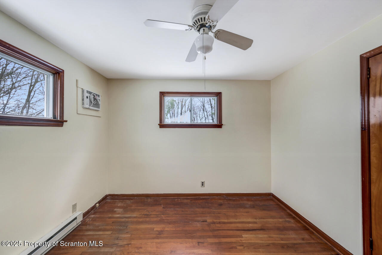 113 Taroli Street Old Forge, PA 18518 - Photo 25 of 41 an empty room with wooden floor ceiling fan and windows