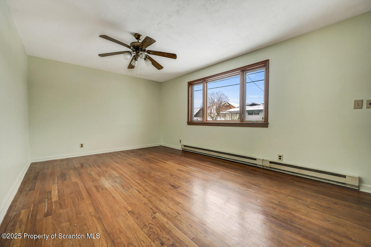 113 Taroli Street Old Forge, PA 18518 - Photo 5 of 41 wooden floor in an empty room with a window